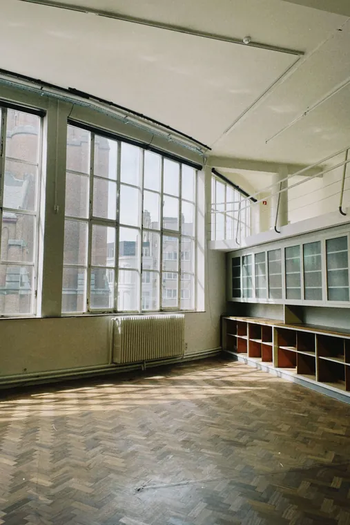 Spacious empty room large glass windows wooden, hardwood flooring